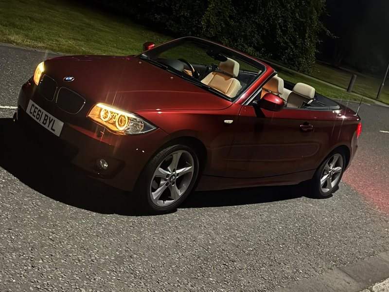 Callum's red BMW E88 118i convertible at night